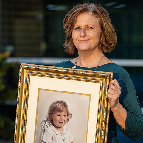 Kris Laraway holding portrait of daughter