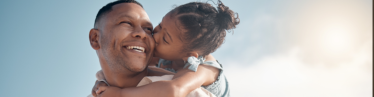 Man holding daughter on his back